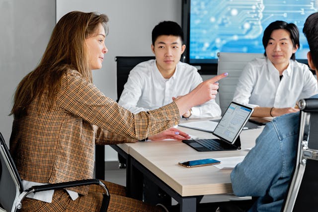 Students in classroom using hybrid LMS on laptops